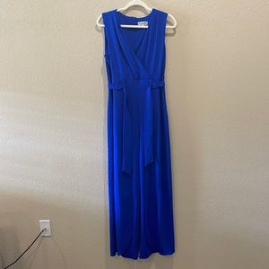 Blue jumpsuit with slits up the front. Size 12.